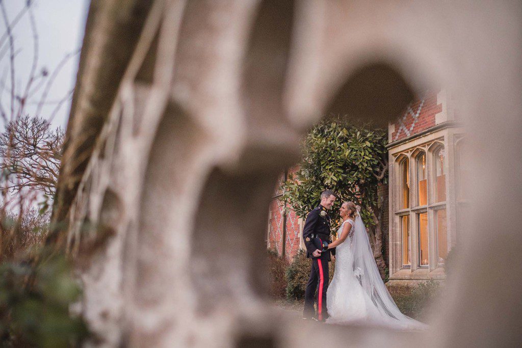 Couple hold hands at on the patio during their Horsted Place Hotel wedding