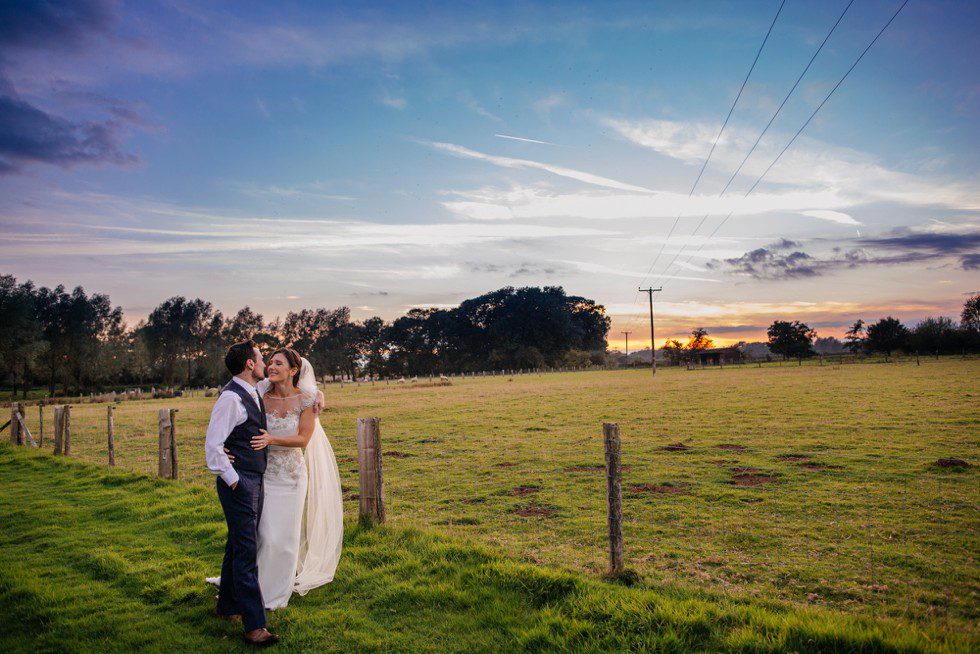 Wedding couple in field at Broyle Place