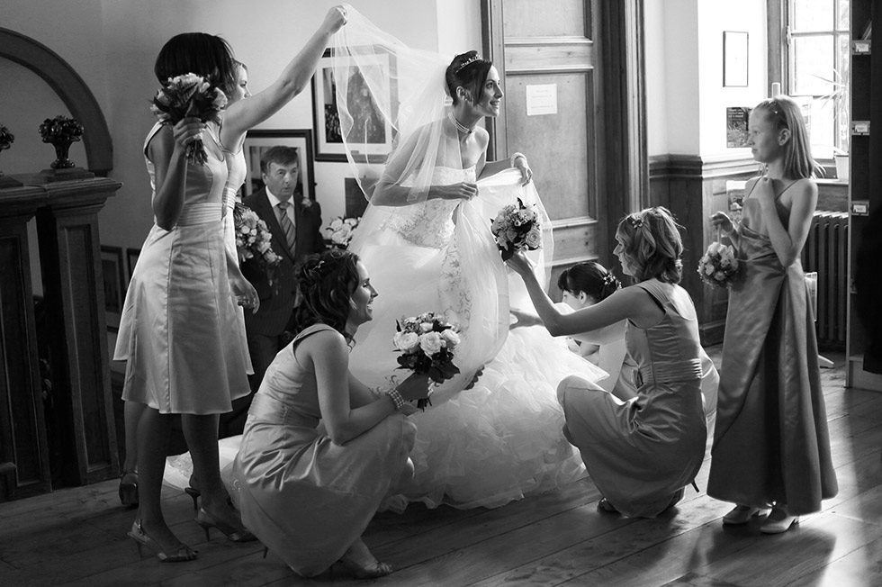 bridal party adjust the bride at Herstmonceux Castle wedding