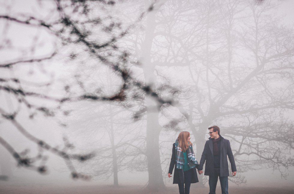 Couple portrait in the mist against a backdrop of trees at Wadhurst Castle