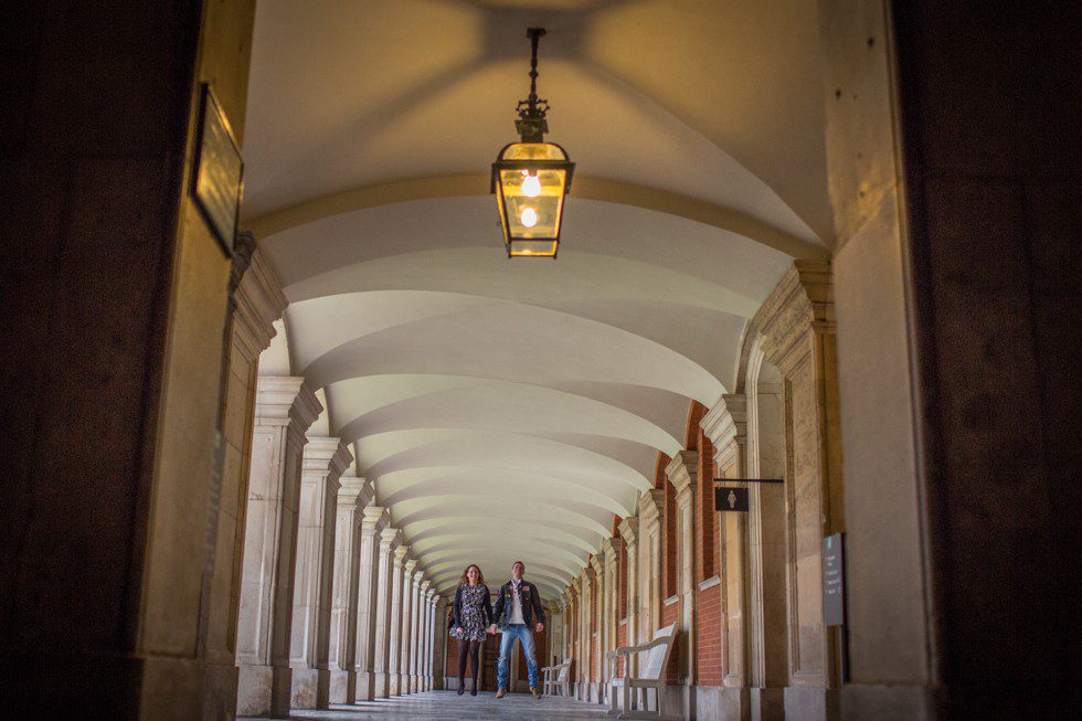 Pre Wedding shoot Hampton Court Palace Couple jump in Cloisters at Hampton Court Palace