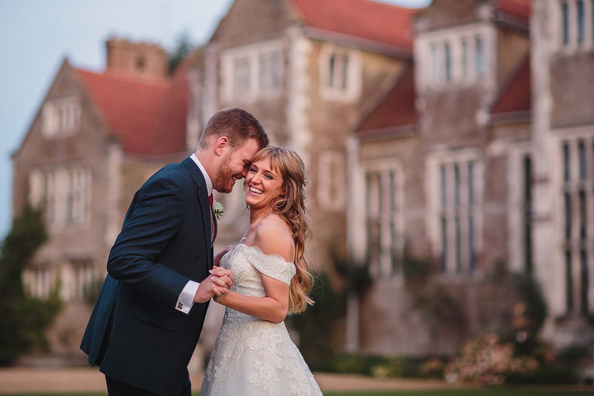 Bride and groom having a fun moment outside Loseley Park in Surrey
