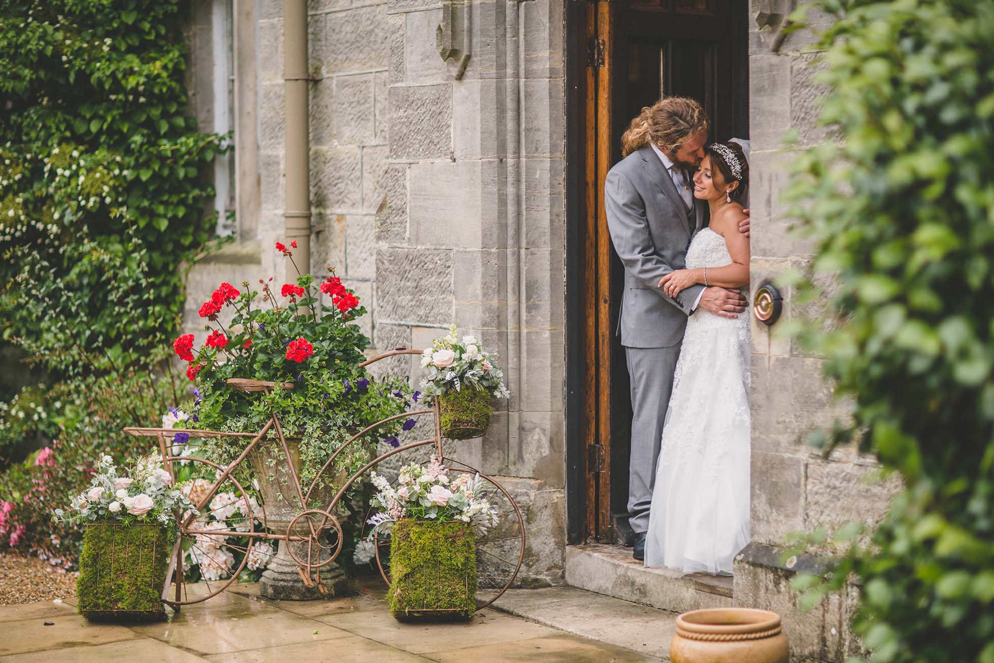 Bride and groom enjoy a quiet moment together at the front of Wadhurst Castle