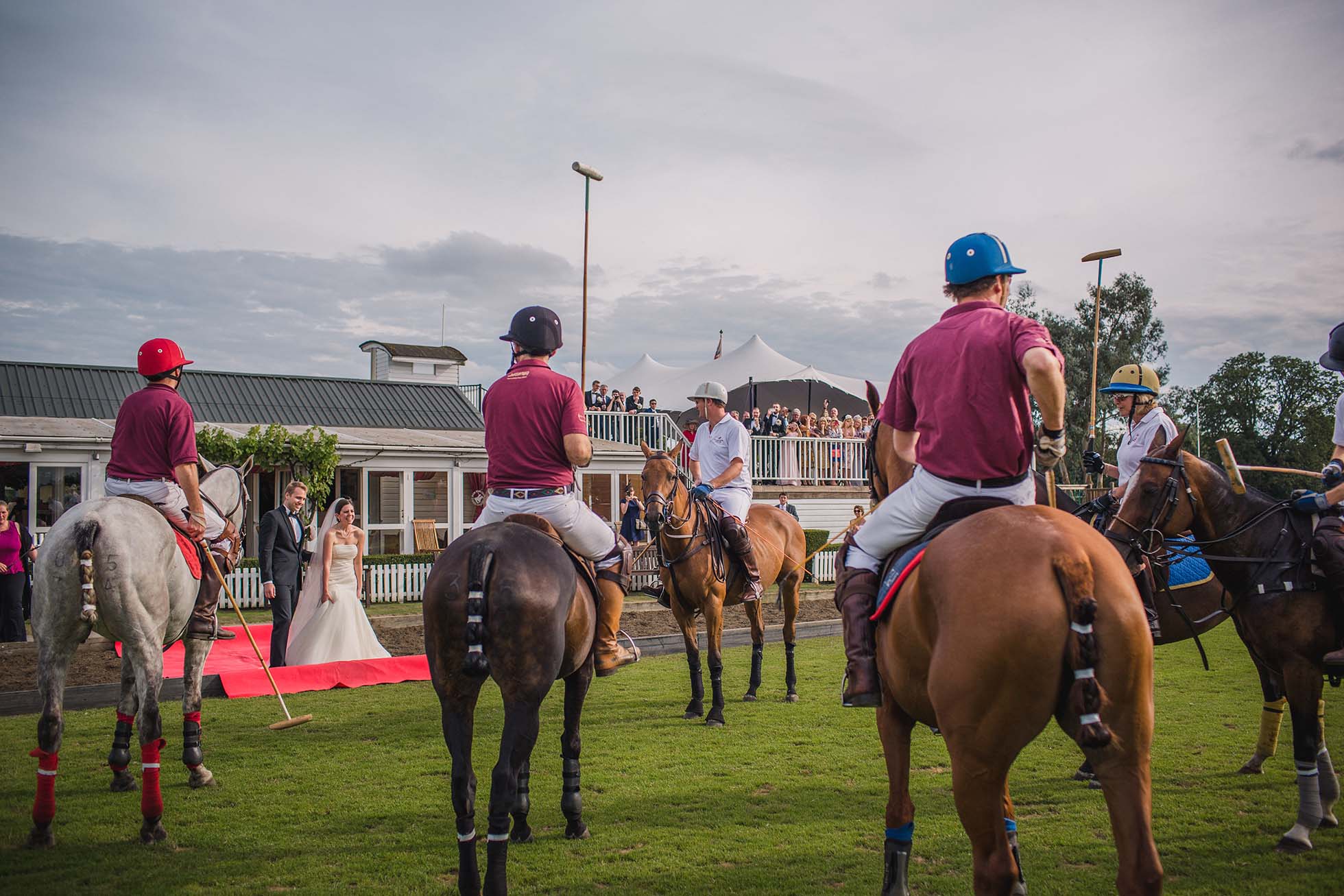 Bride and groom throw in the polo ball to start the polo match during their Ham Polo Club wedding