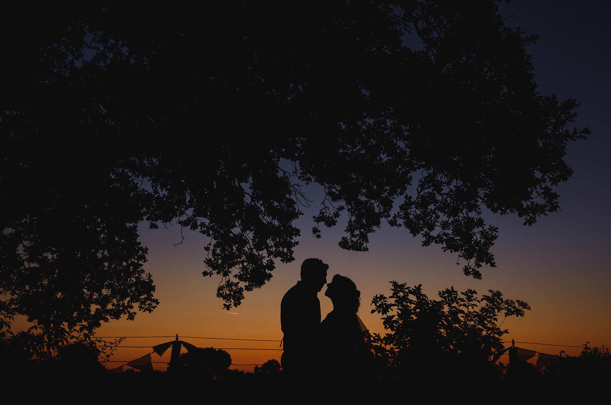 Sunset wedding silhouette in a field in Ripe, East Sussex