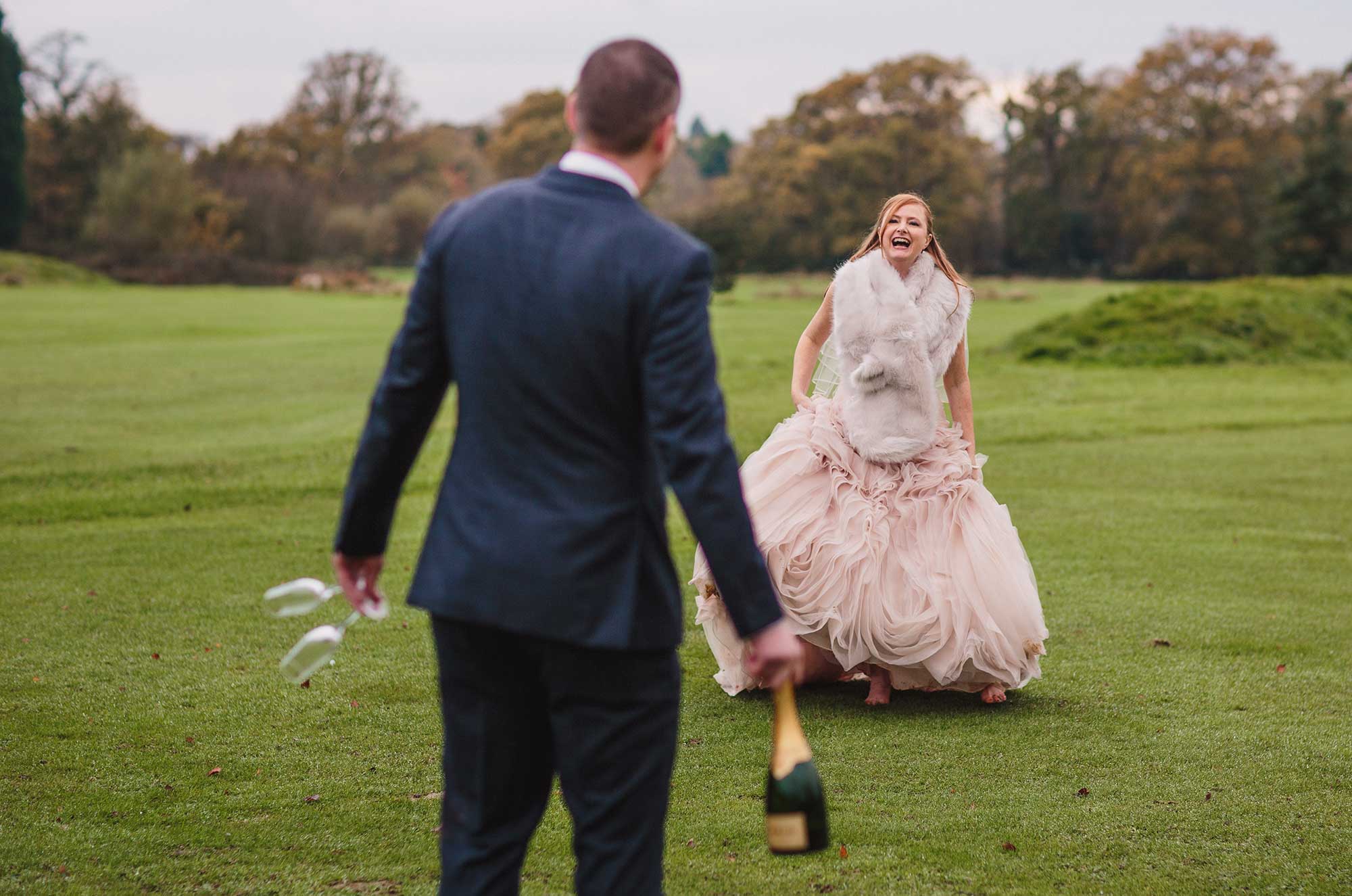 Groom approaches happy bride with Champagne