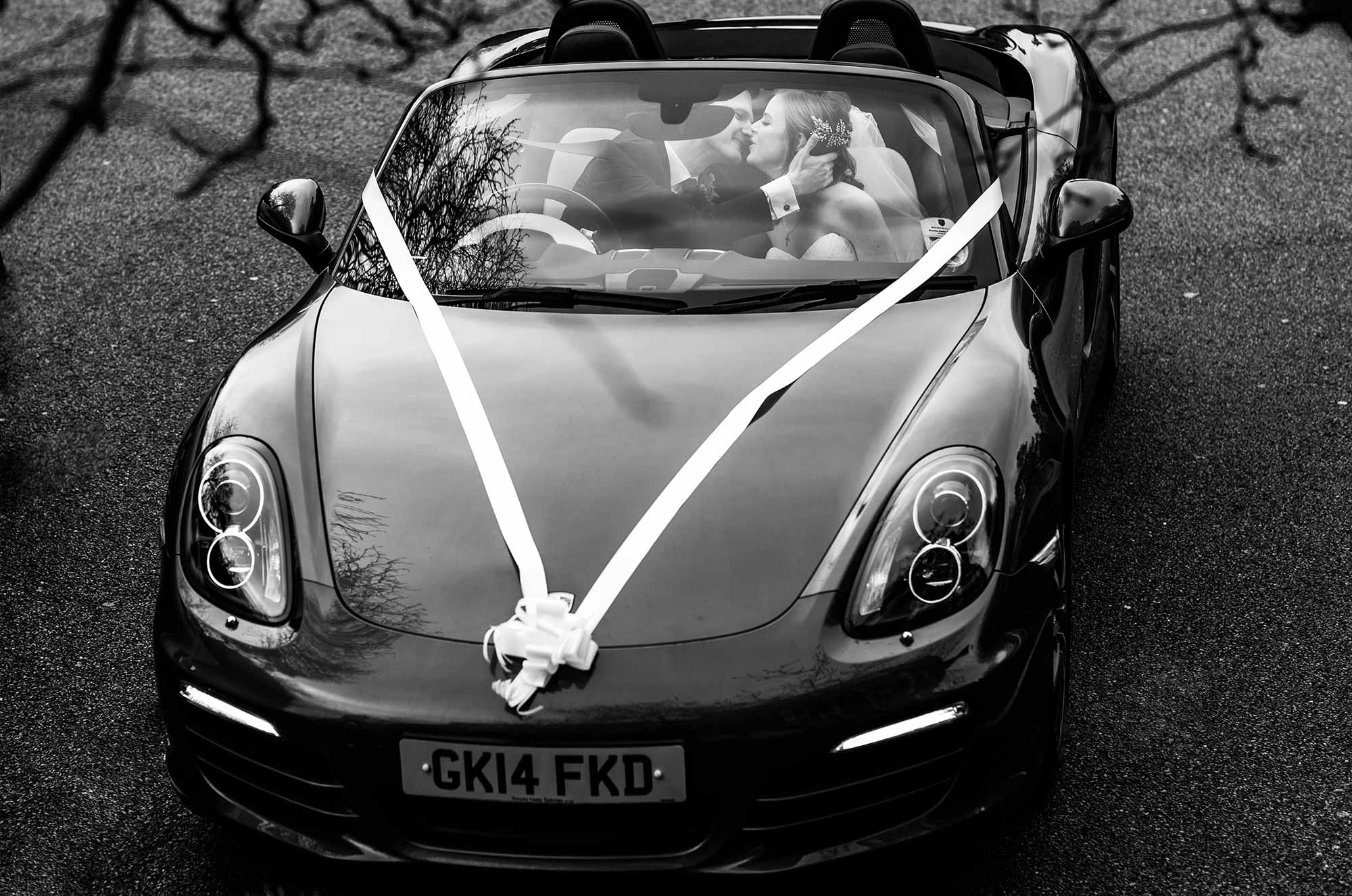 bride and groom kiss in Porsche at Brands Hatch Hotel