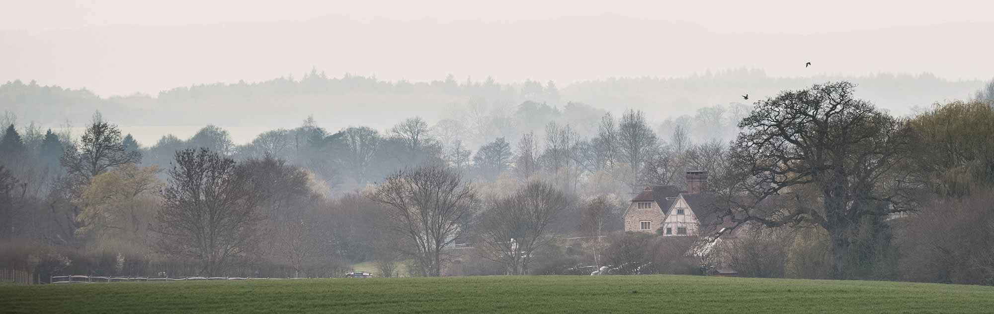 Grittenham Barn wedding venue in amongst the landscape, shot from across the fields