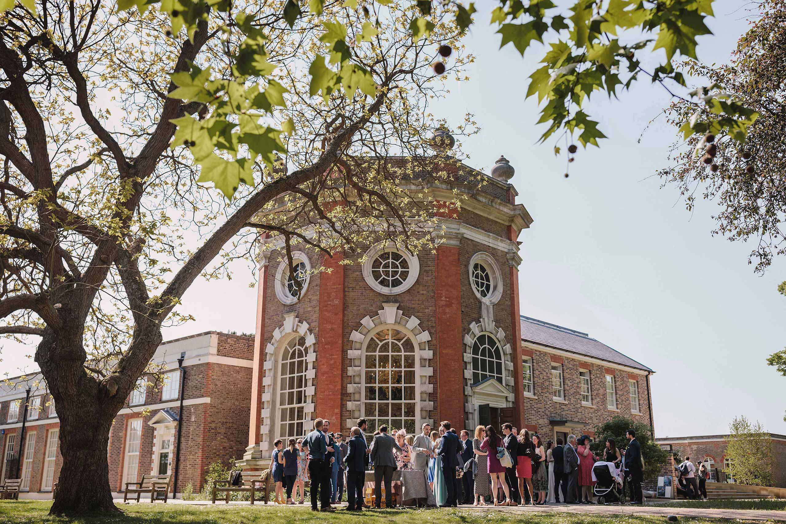 Wedding guests enjoying drinks outside Orleans House Gallery