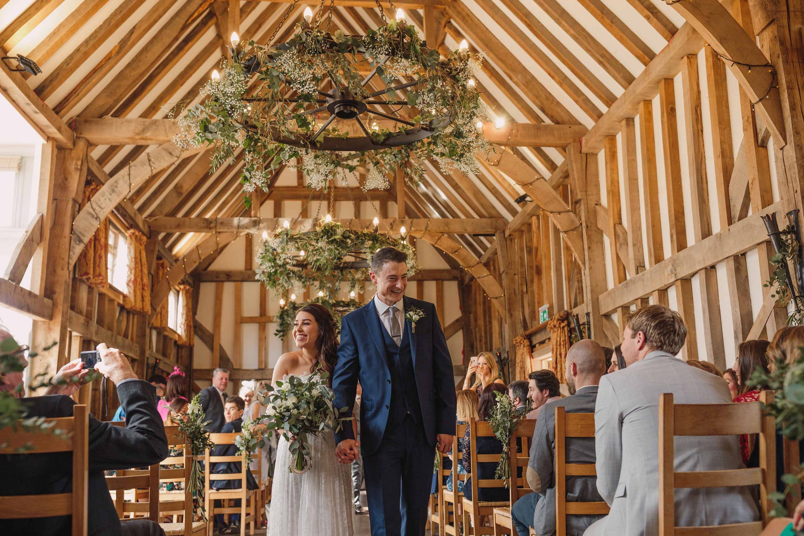 Bride and groom walking down the aisle after their Gate Street Barn wedding.