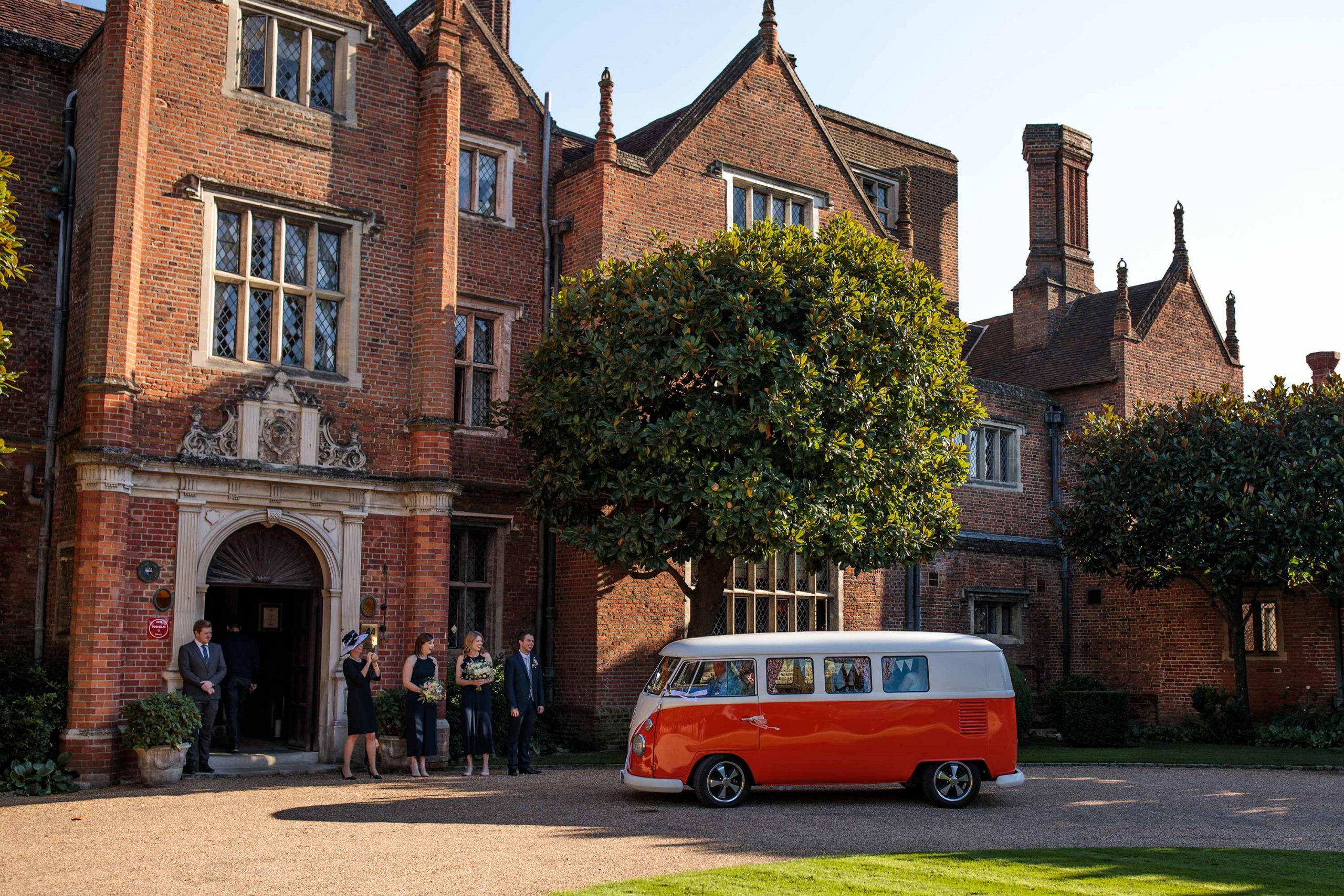 Vintage VW Camper Van delivers the bride at a Great Fosters wedding 