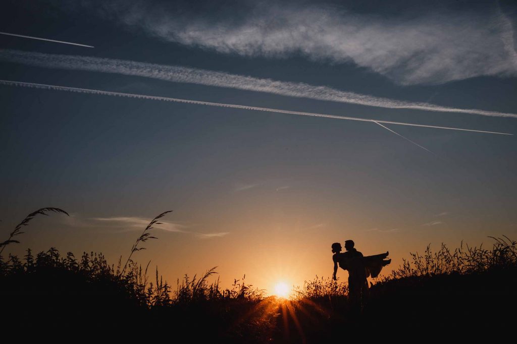 bride and groom silhouette at sunset