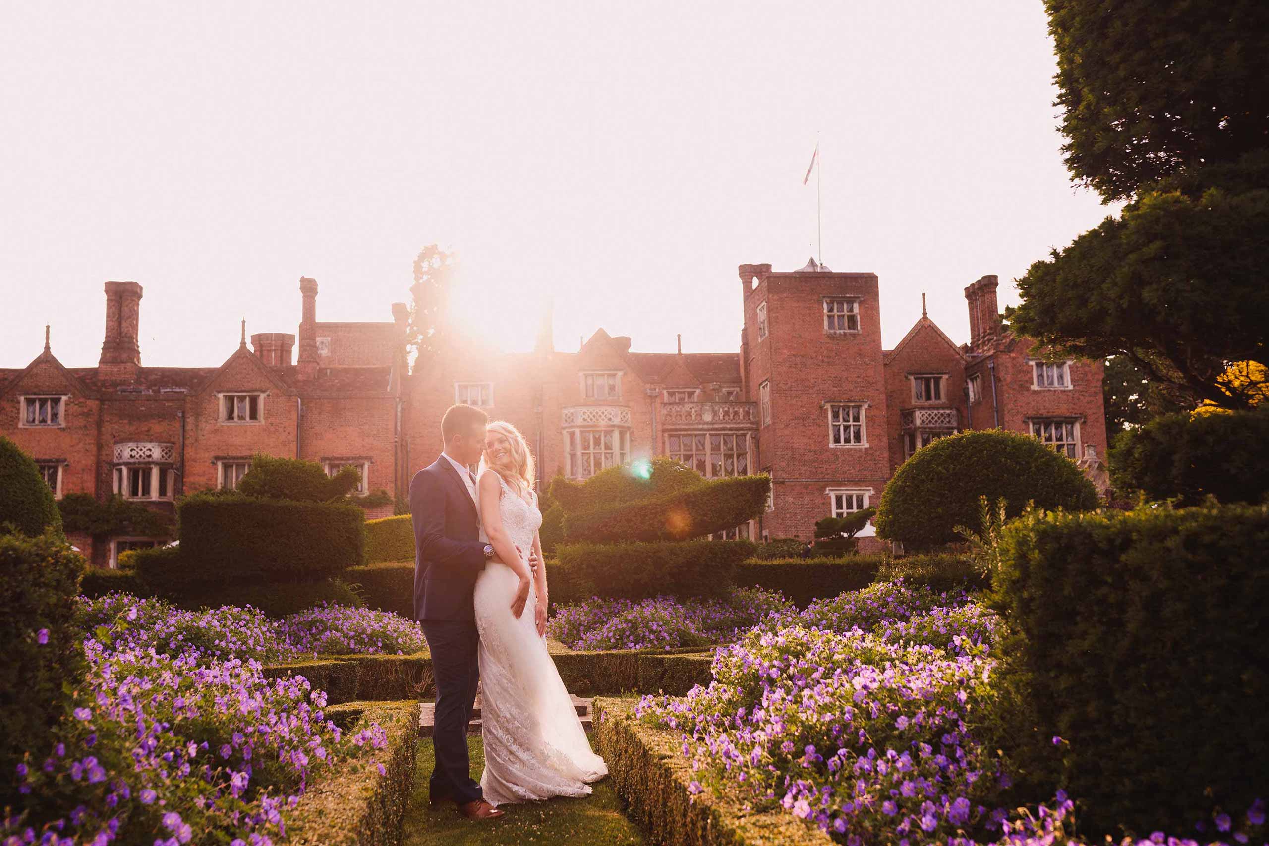 Groom embracing bride in the golden hour at their Great Fosters wedding.