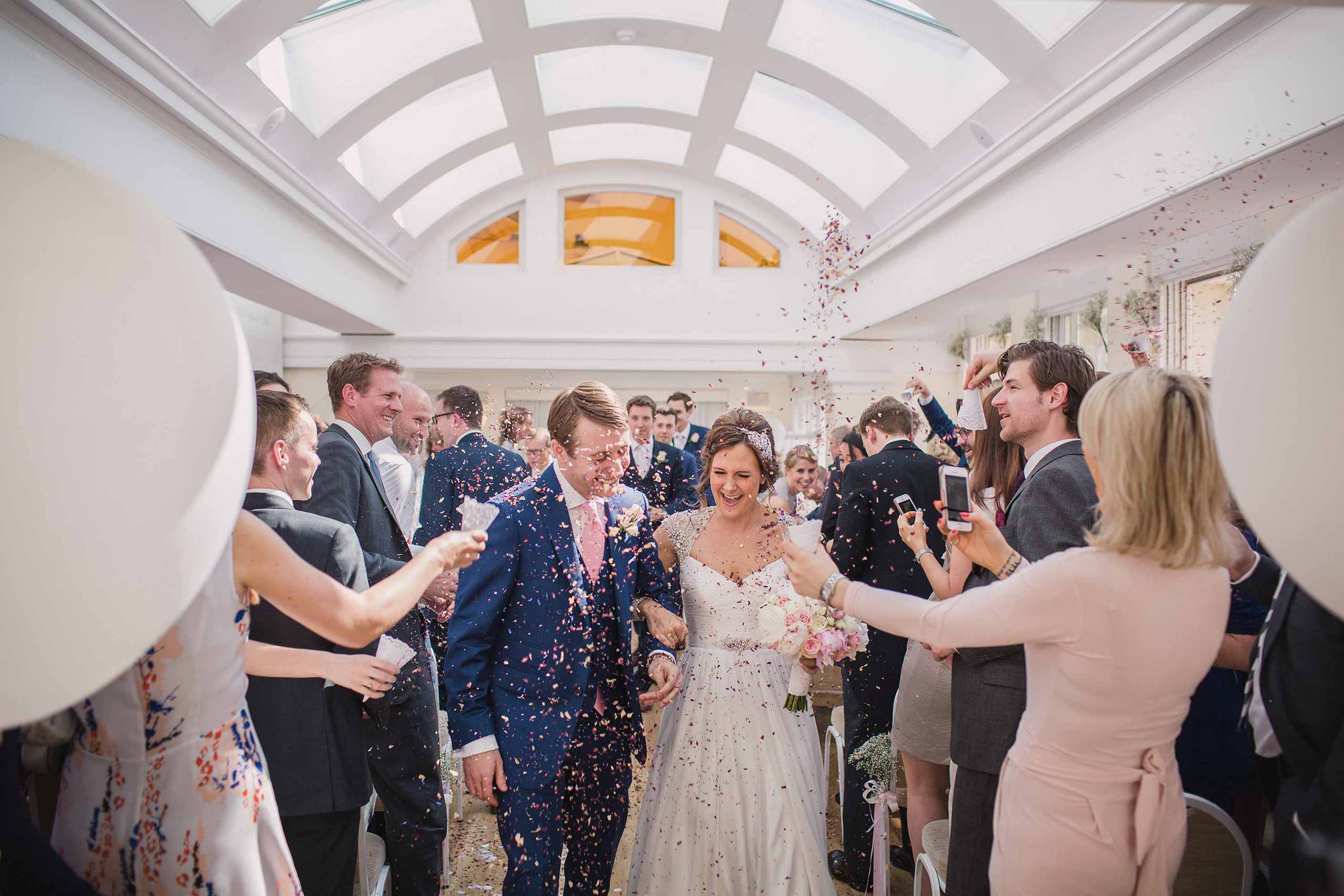 Confetti shower inside Pembroke Lodge wedding venue