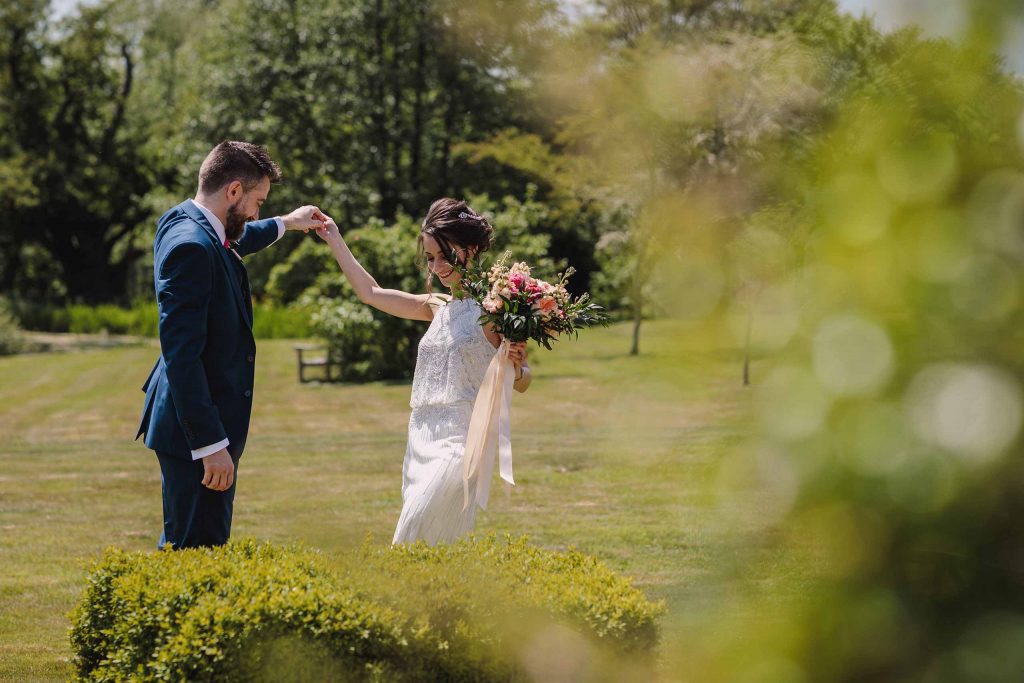 Bride and groom dance in the gardens at Grittenham Barn