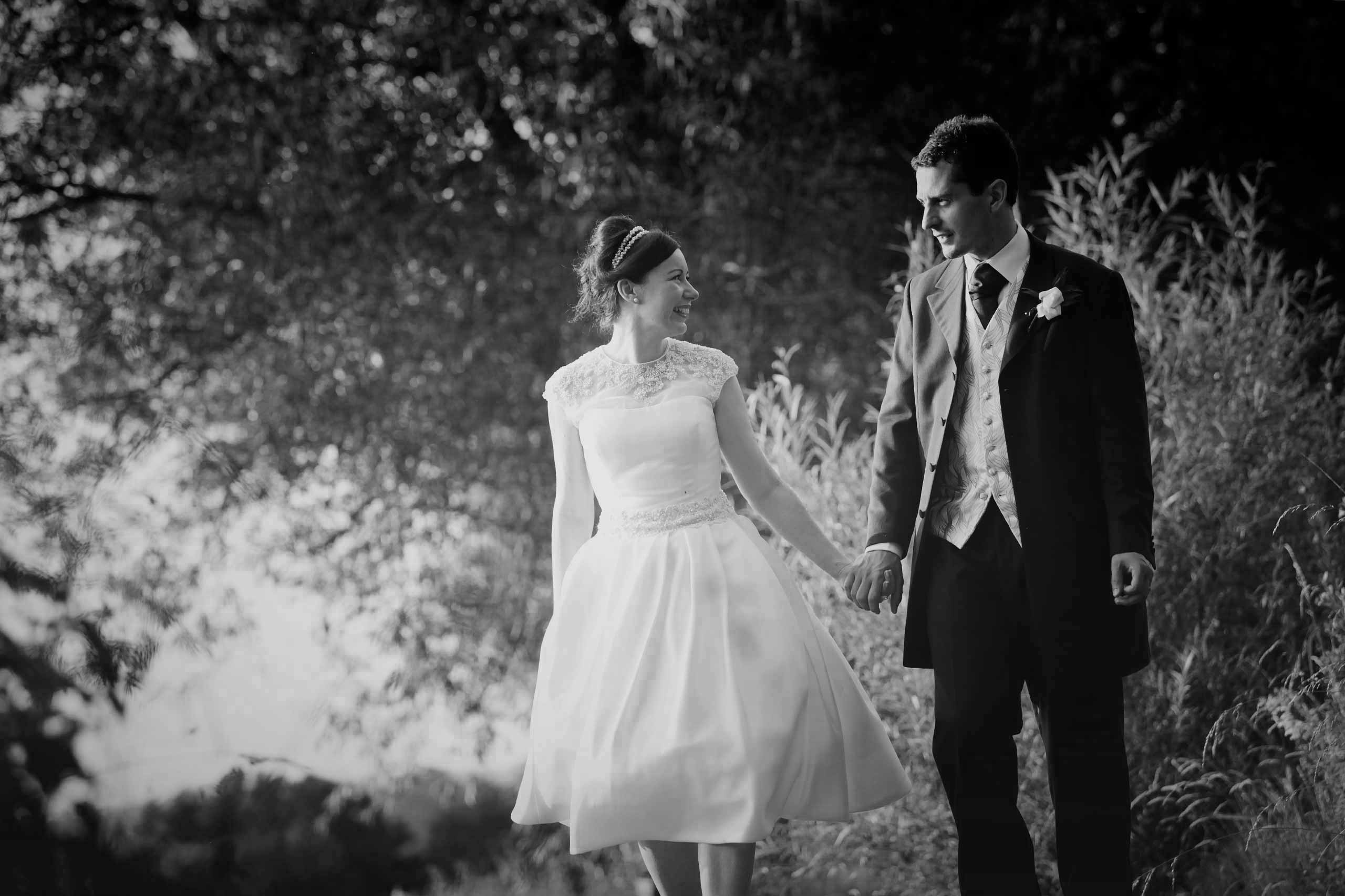 50's bride and groom walking hand in hand at their coltsford mill wedding