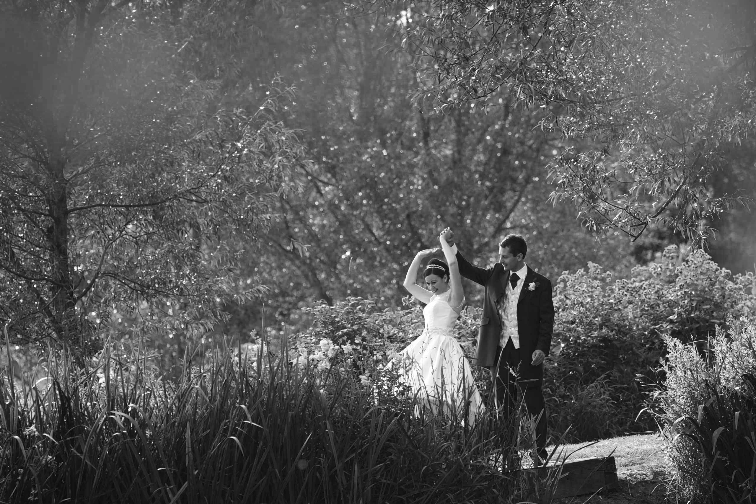 50's bride and groom dancing by the lake at their coltsford mill wedding
