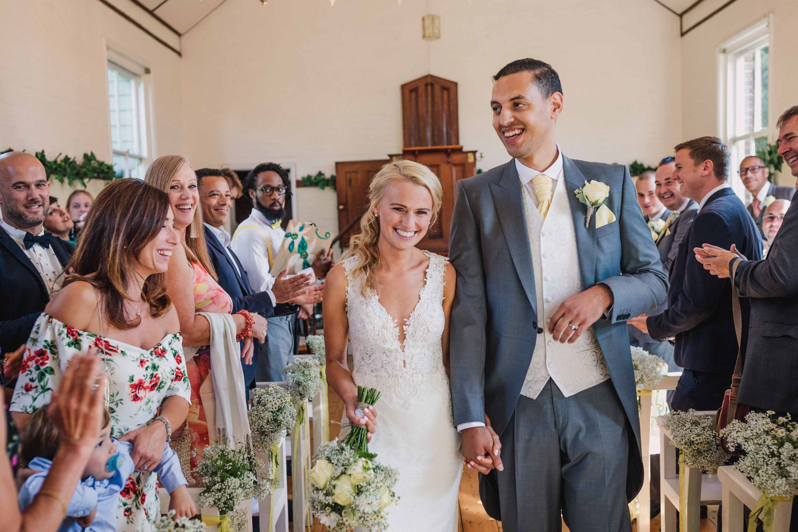 Couple walking down the aisle at their Sussex Chantry wedding ceremony