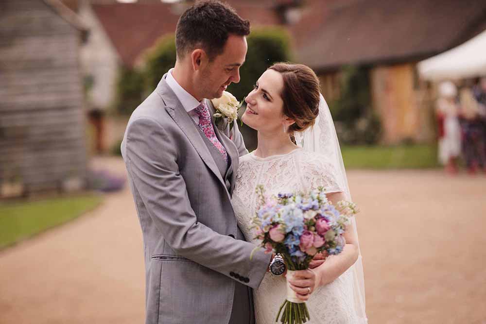 Bride and groom caress after their wedding ceremony