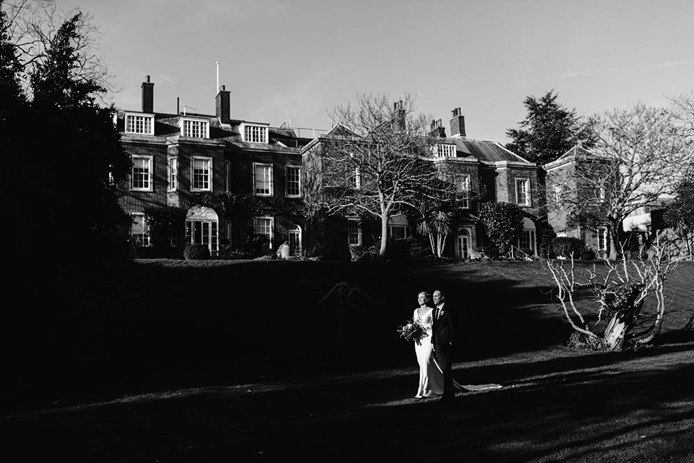 Bride and groom stroll around the grounds of Pelham House in Lewes
