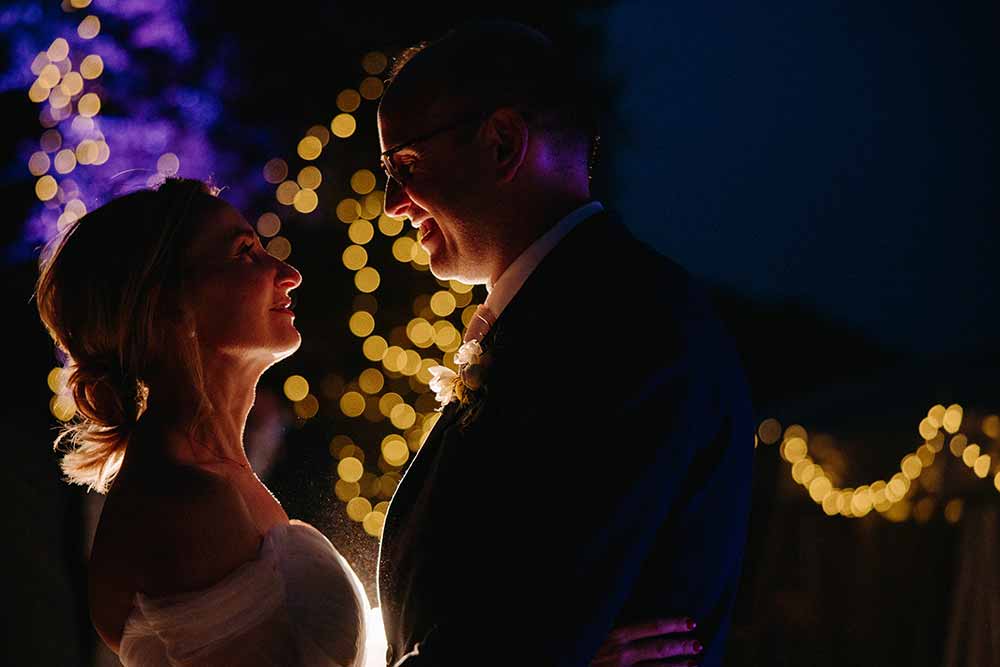 Bride and groom with fairy lights at Devils Dyke Farm wedding