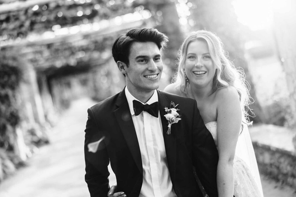 Bride and groom smiling in the Italian Gardens at Hever Castle