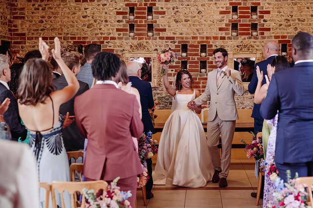 Walk down the aisle after Upwaltham Barns wedding ceremony