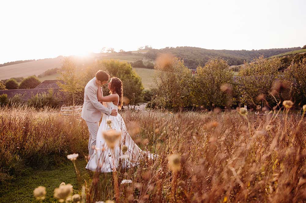 Bride and Groom at Golden hour at their Upwaltham Barns wedding on the South Downs