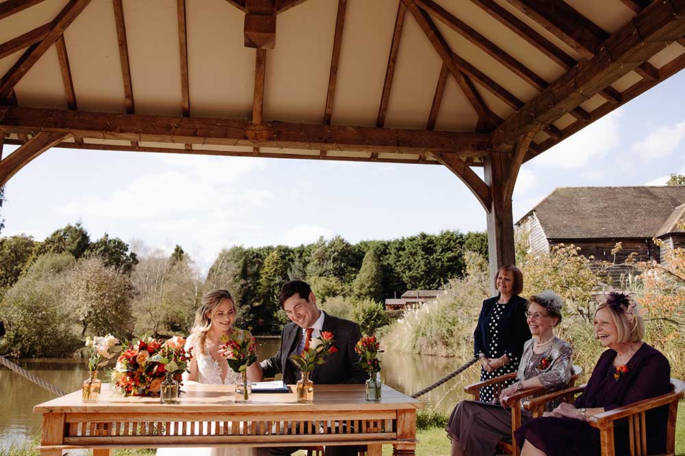 Signing of the register at a Brookfield Barn wedding
